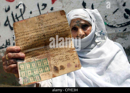 May 15, 2007 - Rafah Refugee Camp, Gaza Strip - 78 year-old Palestinian lady RASMIA AL-AKARAS presents a paper proving the ownership of her house in Wadi Hanin Village beside Beersheba in the occupied territories since 1948, on the 59th anniversary of the 'Nakba (catastrophe ) Day'. She now lives in Stock Photo