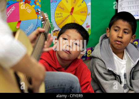 May 16, 2007, Oceanside, California At San Luis Rey Elementary School first graders BRIAN GARCIA, left, and BRYANT MENDEZ watch watching the guitar playing of their teacher JENNY REES Mandatory Credit: photo by Charlie Neuman/San Diego Union-Tribune/Zuma Press. copyright 2007 San Diego Union-Tribune Stock Photo