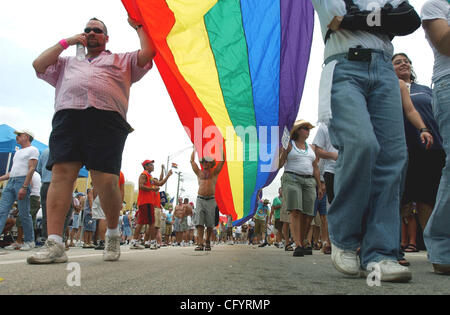 JUNE 18, 2006 WILTON MANORS, FLORIDA- Parade participants carry a pride flags as they march down Wilton Drive during the 7th annual Stonewall Street Festival in Wilton Manors, Florida. The one day festival allows gay and lesbians to come together in the city where alot of them reside. PHOTO BY JOSH 