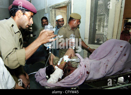 Indian paramilitary soldiers carry their wounded colleague on stretch at a local hospital in Srinagar, India, Friday, June 1, 2007. Two militants and a trainee of a Police training centre were killed and five cadres injured after the militants ambushed an Army convoy at Sheeri in this north Kashmir  Stock Photo