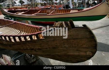 June 17, 2007, San Diego, CA, USA.  The 17th annual Wooden Boat Festival in San Diego was held this weekend on Shelter Island. Everything from sabots to canoes, sailing yachts and power cruisers lined the docks behind Koehler Kraft Boatyard. In a sort of 'before' and 'after' display, two canoes, one Stock Photo