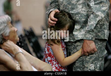 June 17, 2007 - St. Paul, MN, USA -  Emily Firkus, 6, holds onto her father David Firkus of S. St. Paul, a soldier in the Minnesota National Guard, following  a farewell ceremony Saturday at the Cedar Street Armory for 51 soldiers from the Minnesota National Guard 347th Personnel Support Detachment  Stock Photo