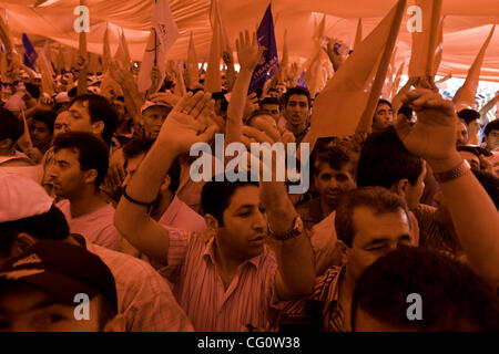 The crowd passed around a huge, red, Turkish flag over their heads during a big rally by the ruling AK Party in Zeytinburnu, Istanbul, Turkey, which drew large crowds but lacked the excitement and energy of the 2003 elections. Abdullah Gül, the minister of foreign affairs, and prime minister Tayyip  Stock Photo