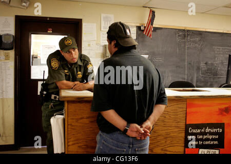 July 23, 2007 Jamul, CA Senior Border Patrol Agent WILL VILLALOBOS, left, processes a person at the Jamul Border Patrol checkpoint, near Dulzura, Calfornia, who was found crossing into the United States from Mexico, near Tecate. Laura Embry/San Diego Union-Tribune/Zuma Press, copyright 2007 San Dieg Stock Photo