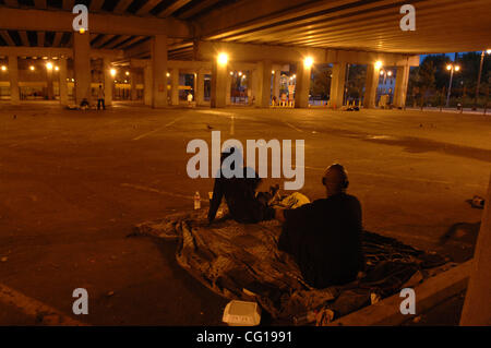 Homeless couples settle in for the night in an empty car park underneath Interstate 75 in downtown Atlanta, GA. ©Robin Nelson Stock Photo