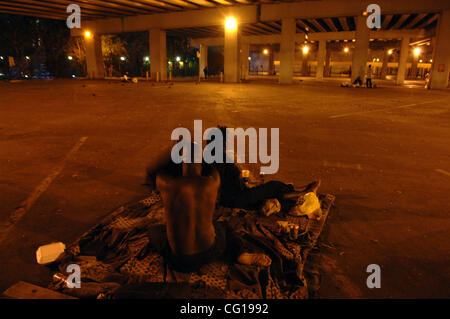 Homeless couples settle in for the night in an empty car park underneath Interstate 75 in downtown Atlanta, GA. ©Robin Nelson Stock Photo