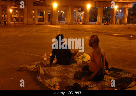 Homeless couples settle in for the night in an empty car park underneath Interstate 75 in downtown Atlanta, GA. ©Robin Nelson Stock Photo