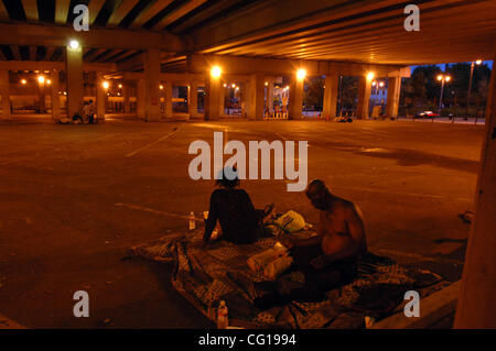 Homeless couples settle in for the night in an empty car park underneath Interstate 75 in downtown Atlanta, GA. ©Robin Nelson Stock Photo