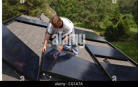Solar photovoltaic panels installed on single family residential roof in Rome, GA. Electrical power generated by the panels will significantly lower the homeowner's energy costs, though the installation costs upwards of $30,000 ©Robin Nelson 2007 Stock Photo