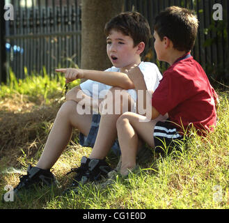 Aug 09, 2007 - Bossier City, LA, USA - Cade McClanahan and Joshua Crews watch as a 9' 8' alligator is pulled out of the Flat River in Bossier City.   (Credit Image: © Jim Hudelson/The Shreveport Times/ZUMA Press) RESTRICTIONS: No Mags No Sales Stock Photo
