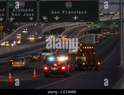 Caltrans workers accompanied by a CHP escort begin the closure of the westbound Interstate 80 on-ramp to the Bay Bridge in Emeryville, Calif. on Friday, August 31, 2007. The Bay Bridge has been closed for the Labor Day weekend and will reopen at 5:00 a.m. Tuesday morning. (Dean Coppola/Contra Costa  Stock Photo