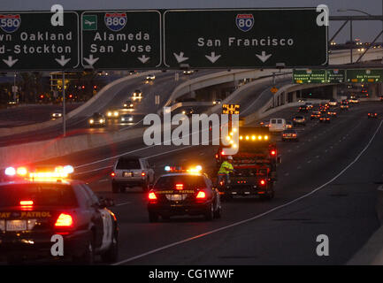 Caltrans workers accompanied by a CHP escort begin the closure of the westbound Interstate 80 on-ramp to the Bay Bridge in Emeryville, Calif. on Friday, August 31, 2007. The Bay Bridge has been closed for the Labor Day weekend and will reopen at 5:00 a.m. Tuesday morning. (Dean Coppola/Contra Costa  Stock Photo