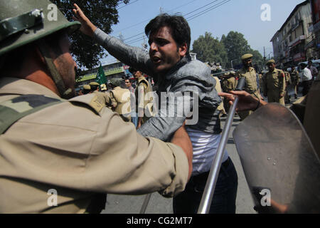 Indian policemen prevent supporters of Kashmir's main opposition People's Democratic Party (PDP) from proceeding forward during a protest march in Srinagar, the summer capital of Indian kashmir on , Wednesday, Oct. 5, 2011. The PDP held a protest march demanding a high level probe into the custodial Stock Photo