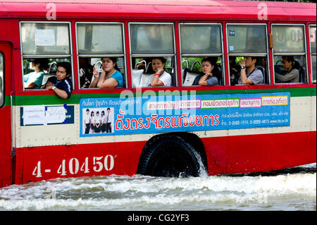 Nov. 10, 2011 - Bangkok, Thailand - Residents travel by bus through flooded street in Bangkok, Thailand. Floodwaters are creeping further into city's center. Thailand is suffering from worst flooding in 50 years. Over 400 people have died due to flooding since late July according to Department of Di Stock Photo