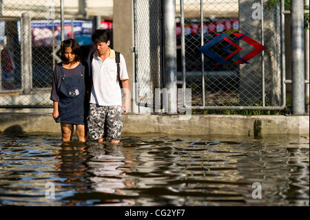 Nov. 10, 2011 - Bangkok, Thailand - Thai residents walk through floodwaters in Bangkok, Thailand. Floodwaters are creeping further into city's center. Thailand is suffering from worst flooding in 50 years. Over 400 people have died due to flooding since late July according to Department of Disaster  Stock Photo