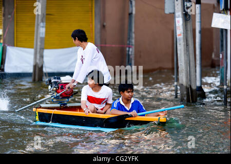 Nov. 10, 2011 - Bangkok, Thailand - Thai residents travel by boat through flooded street in Bangkok, Thailand. Floodwaters are creeping further into city's center. Thailand is suffering from worst flooding in 50 years. Over 400 people have died due to flooding since late July according to Department Stock Photo