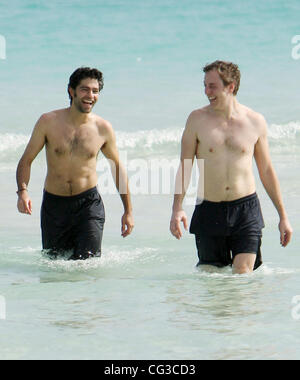 Adrian Grenier and a friend take a dip in the sea on Miami Beach  Miami, Florida, USA - 03.01.11 Stock Photo