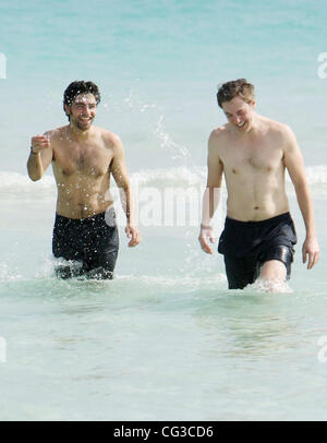 Adrian Grenier and a friend take a dip in the sea on Miami Beach  Miami, Florida, USA - 03.01.11 Stock Photo