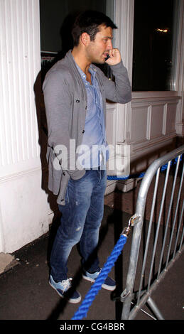 Mark Wright takes a call outside Funky Mojoe club In South Woodford Essex, England - 28.01.11 Stock Photo