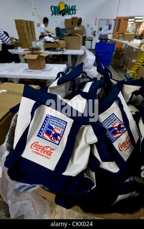 Aug. 24, 2012 - Tampa , FL, USA -  Developmentally disabled workers at the MacDonald Training Center fill the 15,000 swag bags that will be distributed to delegates, VIP's and the media attending the Republican National Convention.  Each bag includes sunglasses, a rain poncho, Mitt Romney's book, 'No Apology: The Case for American Greatness,' a guide to the 2012 RNC, a pocket copy of the Constitution and other hospitality items. Stock Photo