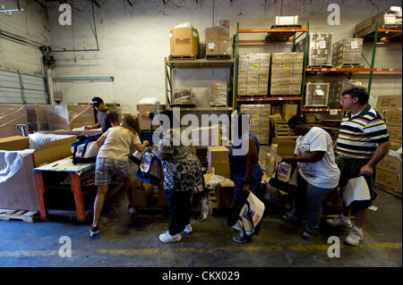 Aug. 24, 2012 - Tampa , FL, USA -  Developmentally disabled workers at the MacDonald Training Center fill the 15,000 swag bags that will be distributed to delegates, VIP's and the media attending the Republican National Convention.  Each bag includes sunglasses, a rain poncho, Mitt Romney's book, 'No Apology: The Case for American Greatness,' a guide to the 2012 RNC, a pocket copy of the Constitution and other hospitality items. Stock Photo