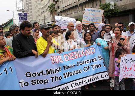 Pakistani Christians and Civil Society members protest against the arrest of a Christian young girl in Karachi August 25, 2012. Rimsha eleven years old was arrested under the blashphemy law B/295C some days ago from the outskirts of Islamabad. Stock Photo