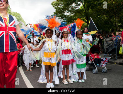 26th Aug 2012. London, UK. Children dancing along the route of Notting Hill Carnival. Stock Photo