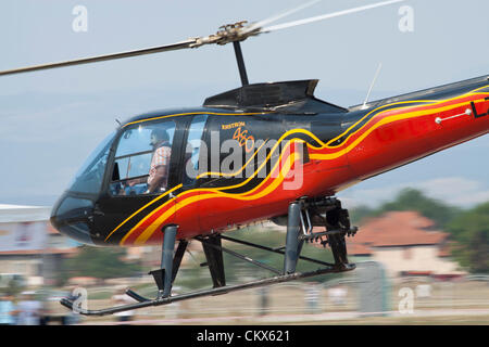 Lesnovo, Bulgaria; 24th Aug 2012. Enstrom 480 light helicopter during a very low fly-by. This aircraft is equipped as a crop duster (note the rack of spray nozzles under the fuselage). Credit:  Johann Brandstatter / Alamy Live News Stock Photo