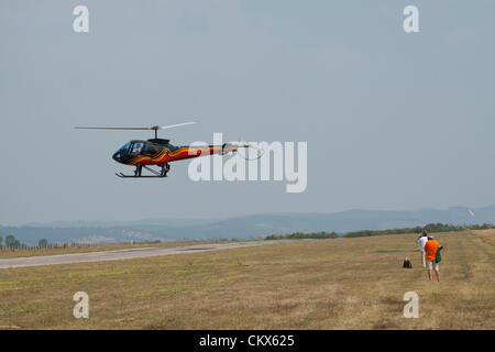 Lesnovo, Bulgaria; 24th Aug 2012. The Enstrom 480 flying sideways over the runway at Lesnovo, giving a perfect show for the many photographers. Credit:  Johann Brandstatter / Alamy Live News Stock Photo