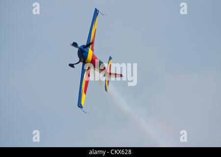 Lesnovo, Bulgaria; 24th Aug 2012. The Hawks of Romania’s star pilot George Rotaru with his Extra 330SC shows a stunning performance at breakneck speed very low over the runway in Lesnovo. Credit:  Johann Brandstatter / Alamy Live News Stock Photo