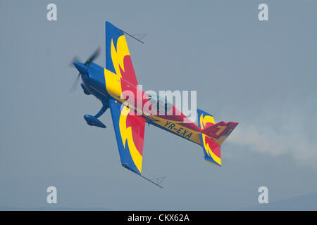 Lesnovo, Bulgaria; 24th Aug 2012. The Hawks of Romania’s star pilot George Rotaru with his Extra 330SC during a low fly-by at breakneck speed over the runway in Lesnovo. Credit:  Johann Brandstatter / Alamy Live News Stock Photo