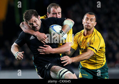 Saturday 25 August 2012. Auckland, New Zealand.  All Blacks' Richie McCaw is tackled by Australia's Ben Alexander and Quade Cooper during the Rugby Championship and Bledisloe Cup Rugby Union test match, New Zealand All Blacks versus Australian Wallabies at Eden Park, Auckland, New Zealand.  Stock Photo