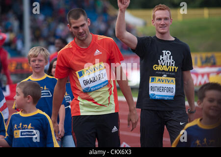 Robert Grabarz and Greg Rutherford, Great Britain 2012 Olympic medal winners waving to the crowd after a lap of honour with local children during the Diamond League Athletics meeting at the Alexander Stadium, Birmingham, UK. Stock Photo