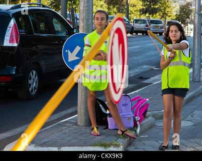 27th Aug 2012. Sixth grade students perform the services of traffic monitoring and assisting younger students in safe access to Yeffe-Nof Elementary School. Jerusalem, Israel. 27-Aug-2012.   Israeli children go back to school today, abolishing traditional Sept. 1st date, in a first stage of reforms initiated by Ministry of Education aiming to shorten summer vacation to 6 weeks, partially relieving parents of enormous financial expenses. Stock Photo