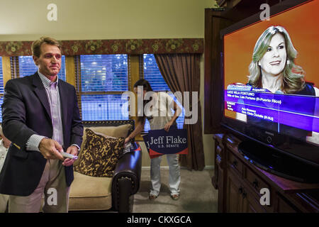 Mesa, Arizona, U.S. Aug. 28, 2012. Rep. JEFF FLAKE (R-AZ) adjusts his TV set in his Mesa, AZ, home while LUCE VELO FORTUNO speaks at the Republican National Convention in Tampa, FL, on the night of Arizona's primary election. Flake is the incumbent Congressman from Arizona's 6th Congressional District. He won the Republican primary for the US Senate seat being vacated by retiring Senator Jon Kyl. Flake faced Arizona businessman and political newcomers Wil Cardon in the primary and won handily. (Credit Image: © Jack Kurtz/ZUMAPRESS.com) Stock Photo