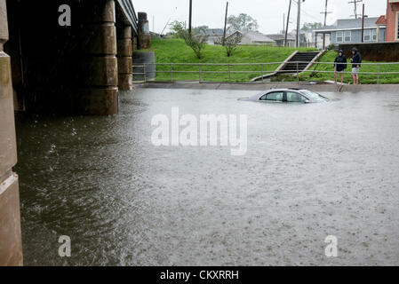 Lakeview, New Orleans. August 29th 2012. 2 cars remain submerged on Canal Boulevard in Lakeview, New Orleans on August 29 2012 after motorists attempt driving through low lying, flooded areas. Tropical Storm Isaac continues to hover over New Orleans while many drivers are unaware of the depths of flooded areas. Stock Photo