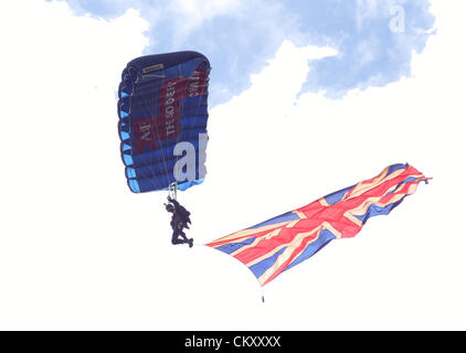 Derbyshire, UK, 31st August 2012.  A member of the Tigers Freefall Parachute Display Team at the opening of Chatsworth Country Fair. The fair is one of the largest outdoor events of its kind in the country held over 3 days (31st August – 2nd September), in the park of Chatsworth House, home to the Duke & Duchess of Devonshire. The fair celebrates British countryside sports and pastimes. Credit:  Matthew Taylor / Alamy Live News Stock Photo