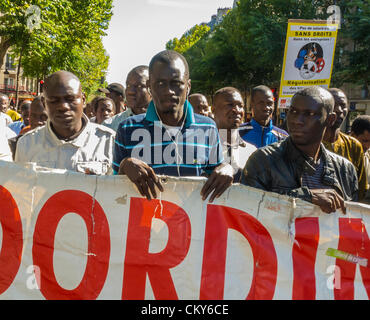 Paris, France, Crowd Marching with Protest Signs and Banners, African Immigrants Without Documents Collective, Migrants, 'Sans Papiers', in Public Demonstration, réfugiés, against immigration rally law protest, immigrant justice, labor, immigrant worker france, protest support immigration rights, illegal migrants, Europe Stock Photo