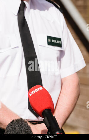 Senior police officer gives a press conference to journalists, including the BBC. Stock Photo