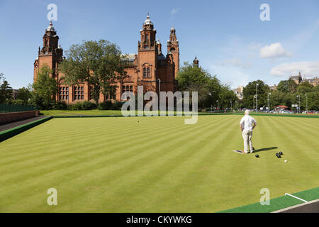 Kelvingrove Lawn Bowls Centre, Glasgow, Scotland, UK, 5th September, 2012. Amateur bowler Jim Hutchison making full use of late summer sunshine to practice his bowling technique at the recently reopened and upgraded lawn bowling greens which will be used in the 2014 Commonwealth Games. Stock Photo