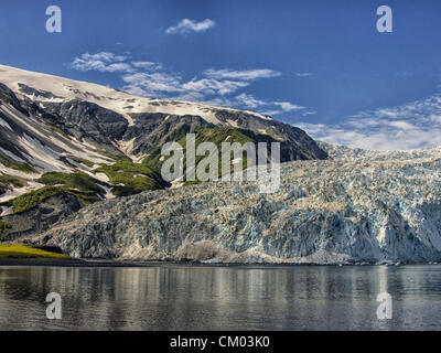 July 1, 2012 - Kenai Peninsula Borough, Alaska, US - The South end of impressive, awe-inspiring, Aialik Glacier, rising some 300 to 400 feet from sea level. At the North end of Aialik Bay off the Gulf of Alaska it is the largest tidewater glacier of Kenai Fjords National Park, its source in the vast Harding Icefield in the Kenai Mountains. Established in 1980, the National Park covers 1,760 square miles of the Kenai Peninsula. (Credit Image: © Arnold Drapkin/ZUMAPRESS.com) Stock Photo