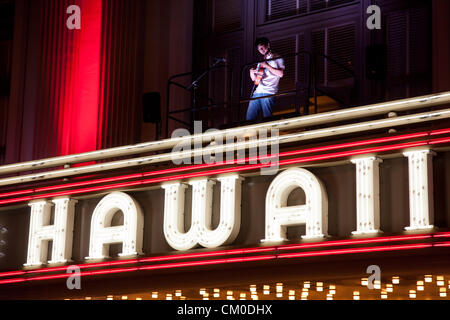 Honolulu, Hawaii. 7th September 2012. Jake Shimabukuro, master of the ukulele plays atop The Hawaii Theater marquee on September 7, 2012 in Honolulu, Hawaii. Jake Shimabukuro is the first person ever to perform on the marquee and is performing in advance of his upcoming release, “Grand Ukulele” produced by Alan Parsons who produced The Beatles “Abby Road” and Pink Floyd’s Dark Side of the Moon”. “Grand Ukulele” also features covers of Adele’s “Rolling In the Deep,” Sting’s “Fields of Gold” and the Judy Garland classic “Over the Rainbow.” Stock Photo