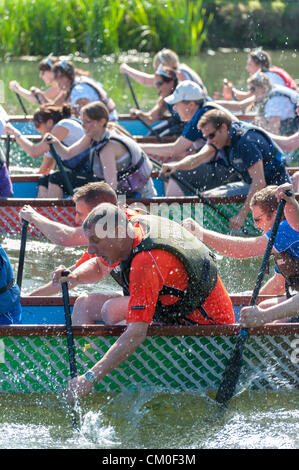 CAmbridge, UK. 8th September 2012. Competitors enjoy the late summer weather at the Cambridge Dragon Boat Festival,  on the River Cam at Fen Ditton Cambridge UK, 8th September 2012.  Around 50 crews from local organisations took part in the races paddling the 30 foot long Chinese dragon boats to raise money for the East Anglian Children's Hospices. Credit:  Julian Eales / Alamy Live News Stock Photo