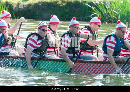 CAmbridge, UK. 8th September 2012. Competitors enjoy the late summer weather at the Cambridge Dragon Boat Festival,  on the River Cam at Fen Ditton Cambridge UK, 8th September 2012.  Around 50 crews from local organisations took part in the races paddling the 30 foot long Chinese dragon boats to raise money for the East Anglian Children's Hospices. Credit:  Julian Eales / Alamy Live News Stock Photo