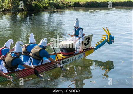 CAmbridge, UK. 8th September 2012. Competitors enjoy the late summer weather at the Cambridge Dragon Boat Festival,  on the River Cam at Fen Ditton Cambridge UK, 8th September 2012.  Around 50 crews from local organisations took part in the races paddling the 30 foot long Chinese dragon boats to raise money for the East Anglian Children's Hospices. Credit:  Julian Eales / Alamy Live News Stock Photo