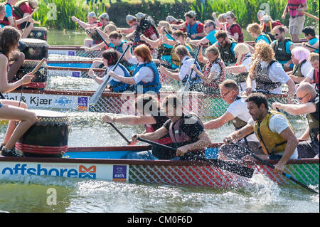 CAmbridge, UK. 8th September 2012. Competitors enjoy the late summer weather at the Cambridge Dragon Boat Festival,  on the River Cam at Fen Ditton Cambridge UK, 8th September 2012.  Around 50 crews from local organisations took part in the races paddling the 30 foot long Chinese dragon boats to raise money for the East Anglian Children's Hospices. Credit:  Julian Eales / Alamy Live News Stock Photo