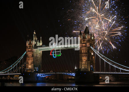 London, UK Sunday 9th September 2012. Fireworks explode around Tower Bridge in the City of London where the 'agitos' Paralympic symbols have been on show since the beginning of the Paralympic Games. Stock Photo