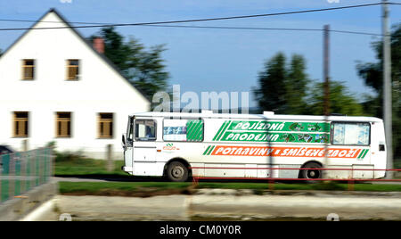 One of the latest mobile shops with the full range of sortiment is in Vysocina region operated by Jednota. Every working day shop on the wheel goes to his customerts even to the smallest villages of Jihlava region (130 kms south-east from Prague). Staff of the shop Lukas Cvach and Vladimir Raiter know their customers by name and in case that regular customer does not manage to come shopping on time, they usually wait. Among the shoppers are mostly mothers on maternity leave, retired people, so basically mainly those who have no possibility to drive the car the supermarket in town. Bus with sho Stock Photo