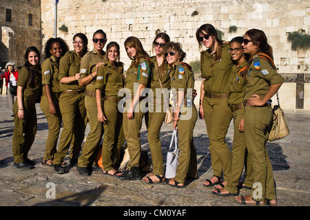 A group of female IDF soldiers pose for a photo at the Western Wall. Jerusalem, Israel. 10-September-2012.   Hibakusha, survivors of the August 6th, 1945 bombing of Hiroshima, visit Israel to promote  nuclear abolition. Calling “No More Hiroshimas, No More Nagasakis!” they place their prayers between the Kotel stones. Stock Photo