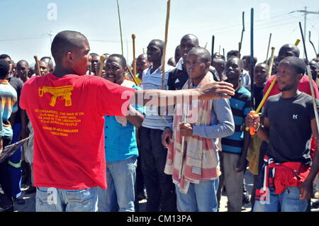 RUSTENBURG, SOUTH AFRICA: Lonmin mine workers march to three different mines demanding that shafts be closed down and workers join them in their wage strike on September 10, 2012 in Rustenburg, South Africa. The workers have been protesting for over three weeks. (Photo by Gallo Images / Dino Lloyd) Stock Photo